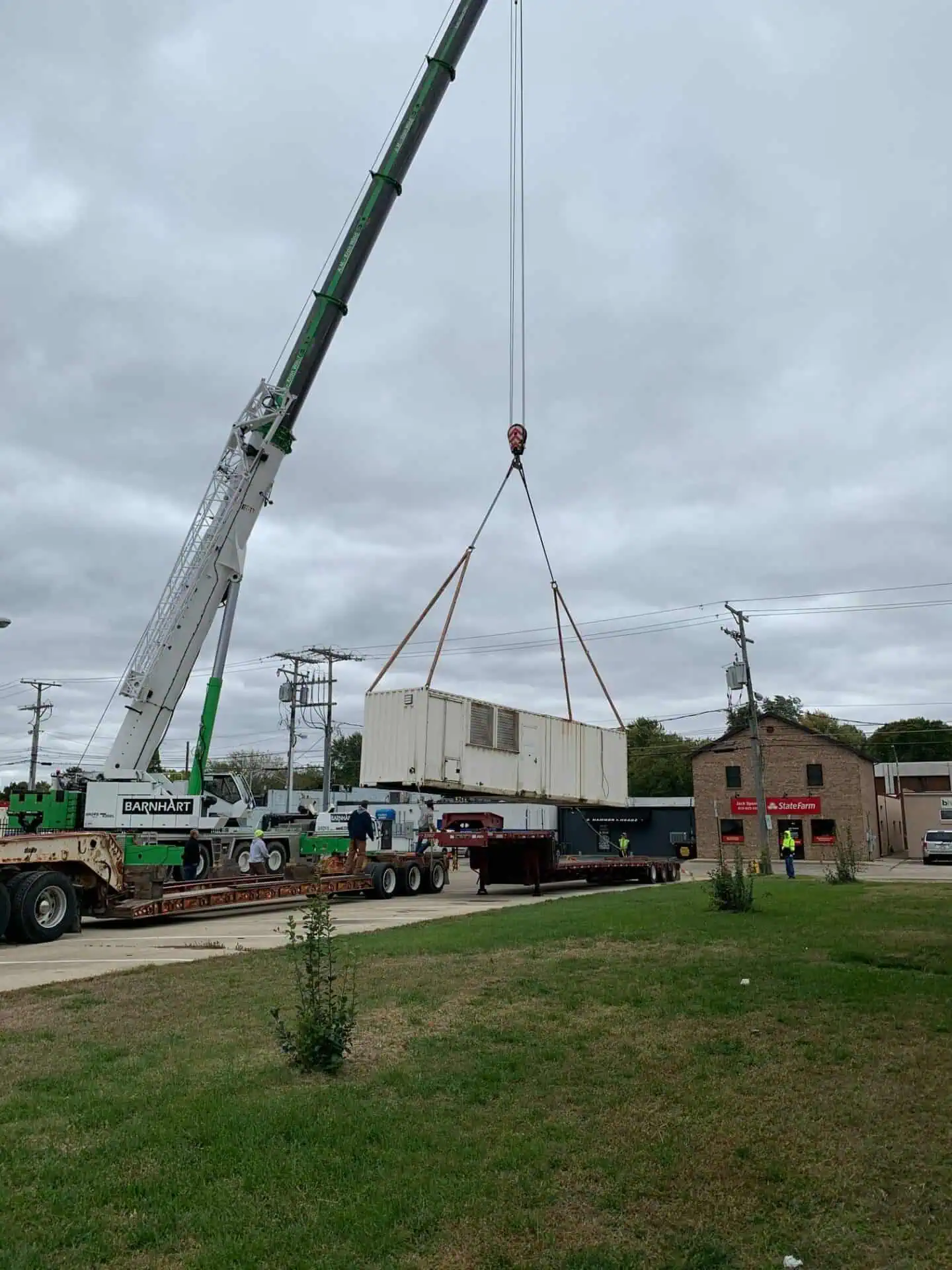 Crane lifting container in an urban setting.